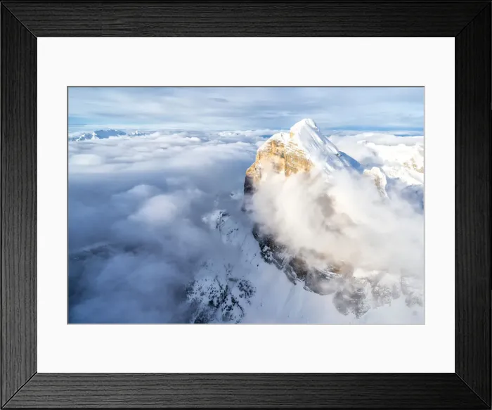 Framed Print : Snow covered Tofana di Rozes above the clouds, aerial view, Dolomites, Belluno province Framed Print : Snow covered Tofana di Rozes above the clouds, aerial view, Dolomites, Belluno province