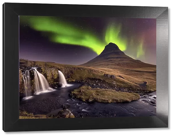 Aurora Borealis (Northern Lights) over Kirkjufell Mountian with a small waterfall in
