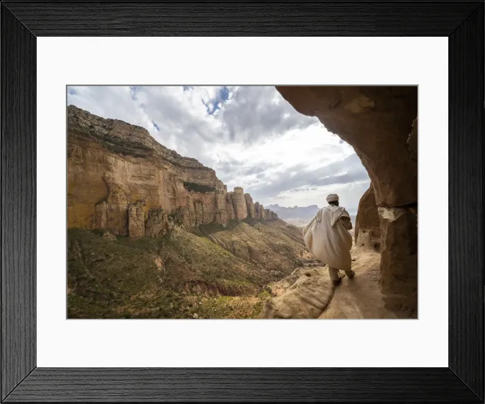 Framed Print : Rear view of priest walking on access trail to the rock-hewn Abuna Yemata Guh church