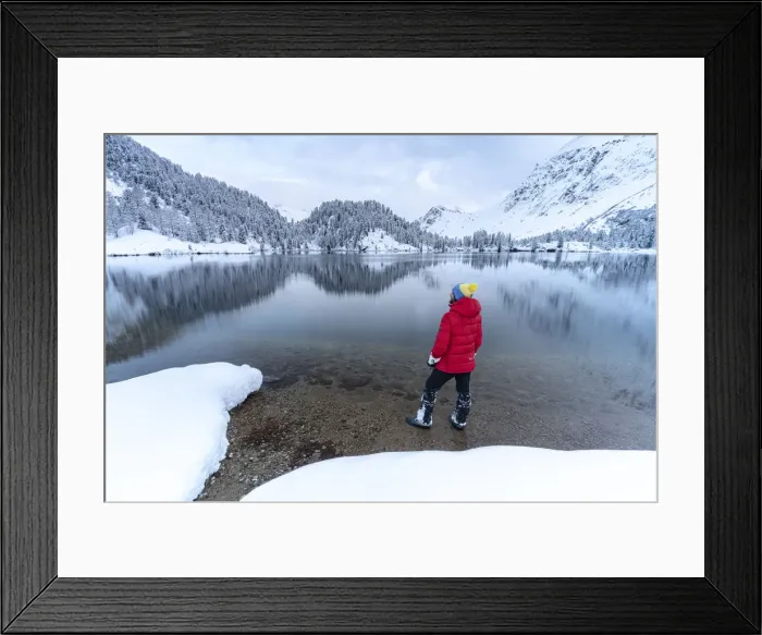 Framed Print : Man standing on shores of Lake Cavloc admiring the snowy woods, Bregaglia Valley Framed Print : Man standing on shores of Lake Cavloc admiring the snowy woods, Bregaglia Valley
