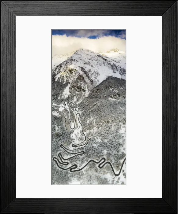 Framed Print : Bends of Maloja Pass road on snowy mountain ridge, aerial view, Bregaglia Valley Framed Print : Bends of Maloja Pass road on snowy mountain ridge, aerial view, Bregaglia Valley