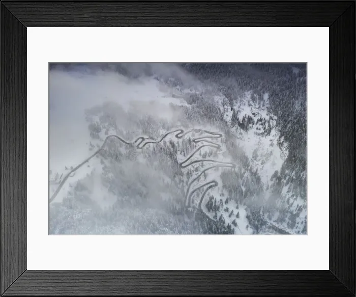 Framed Print : Fog on bends of Maloja Pass road and snowy woods, aerial view, Bregaglia Valley, Engadine