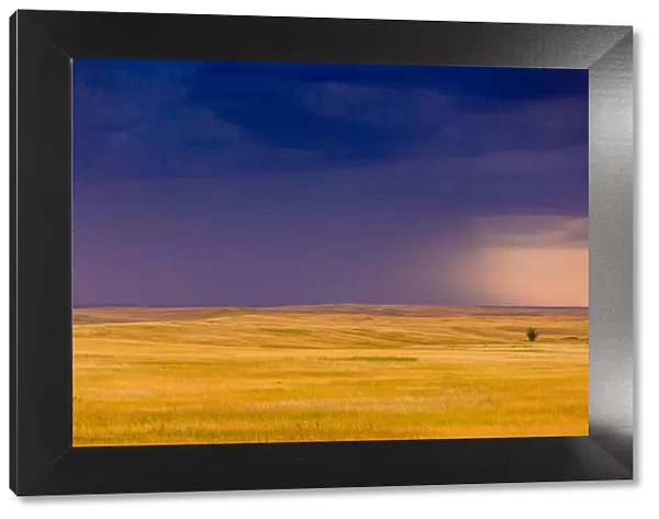 Rolling plains against a dark stormy sky in the Badlands, South Dakota