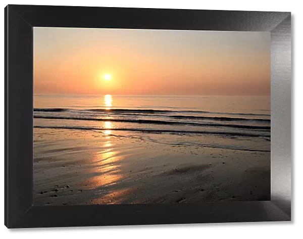 Sunrise over calm sea on the east coast of England, Walberswick, Suffolk, England