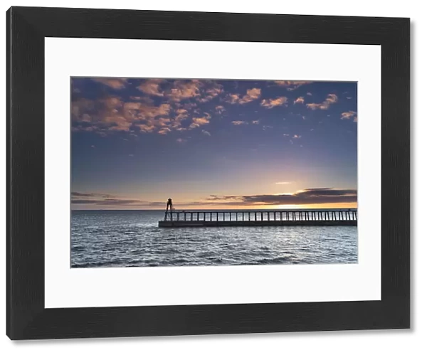 Sunrise over the North Sea and Whitby harbour and piers in late summer, Whitby