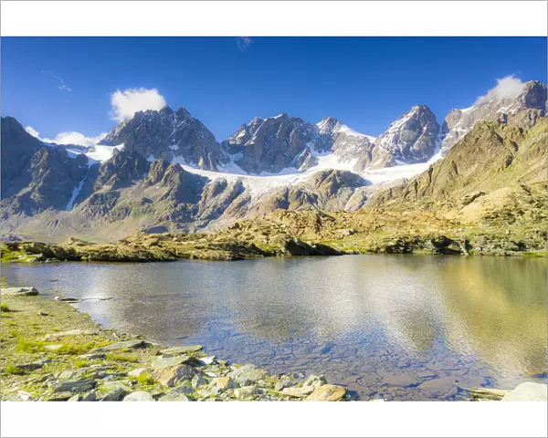 Clear sky over the rocky peaks of Bernina Group and Forbici lake in summer, Valmalenco