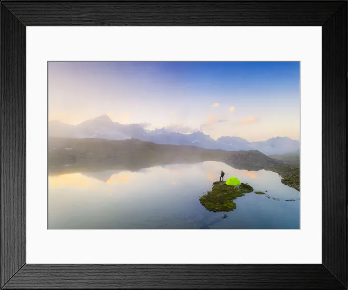 Framed Print : Hiker man with tent admiring a misty sunrise over mountains from Obere Schwarziseeli lake Framed Print : Hiker man with tent admiring a misty sunrise over mountains from Obere Schwarziseeli lake