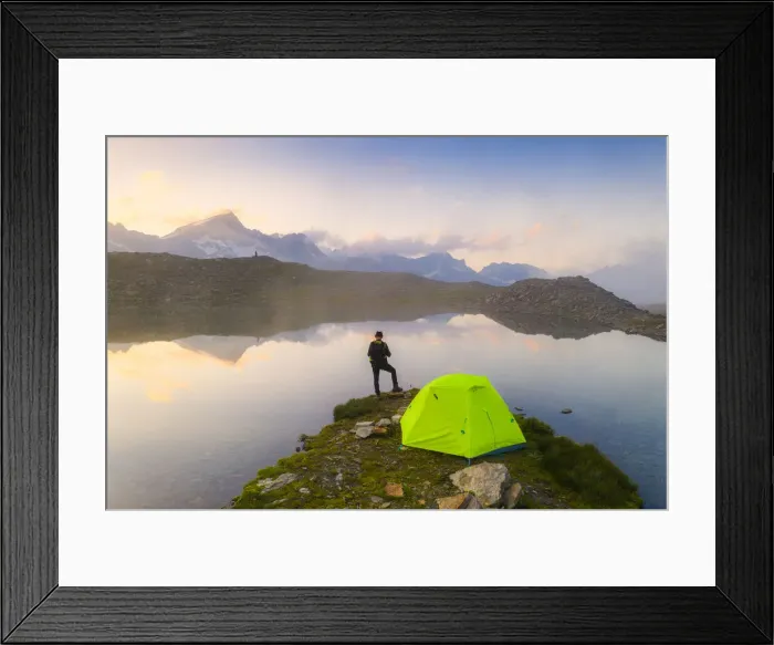Framed Print : Rear view of man with hat standing outside tent at Obere Schwarziseeli lake at dawn Framed Print : Rear view of man with hat standing outside tent at Obere Schwarziseeli lake at dawn
