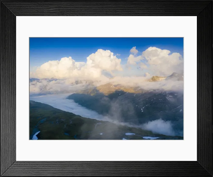 Framed Print : Sunlight over mountains in the fog, aerial view, Furka Pass, Canton Uri, Switzerland Framed Print : Sunlight over mountains in the fog, aerial view, Furka Pass, Canton Uri, Switzerland