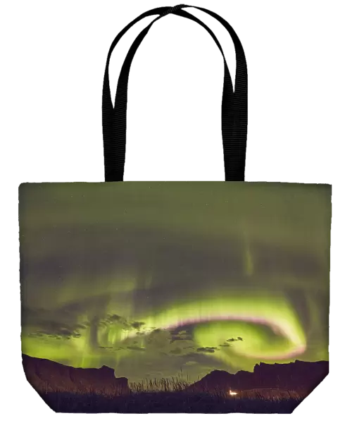 The Aurora Borealis (Northern Lights), seen in the night sky above Vik