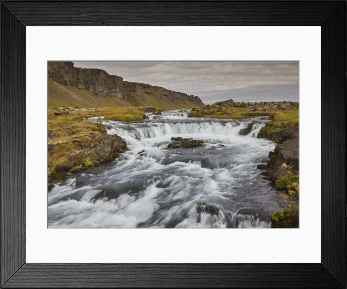 Framed Print : A classic Icelandic landscape, a river flowing along the base of a cliff Framed Print : A classic Icelandic landscape, a river flowing along the base of a cliff