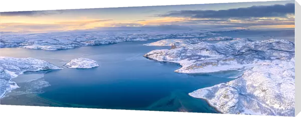 Arctic sunrise over the frozen sea and mountains covered with snow, Laksefjorden, Lebesby