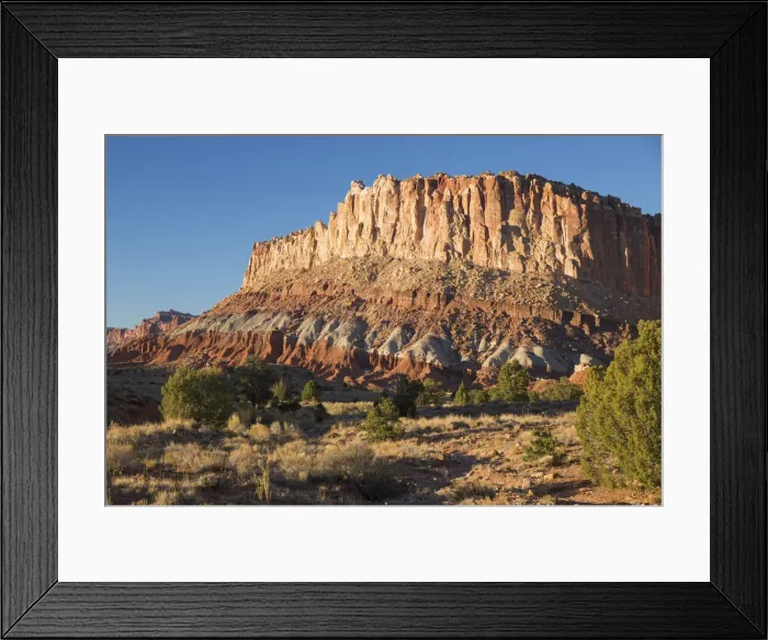 Framed Print : Sandstone cliffs of the Waterpocket Fold towering above Scenic Drive, sunset, Fruita Framed Print : Sandstone cliffs of the Waterpocket Fold towering above Scenic Drive, sunset, Fruita