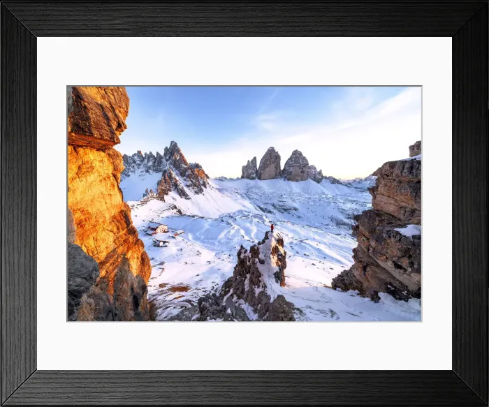 Framed Print : Man on rocks admiring the snowy Monte Paterno and Tre Cime di Lavaredo at sunset Framed Print : Man on rocks admiring the snowy Monte Paterno and Tre Cime di Lavaredo at sunset