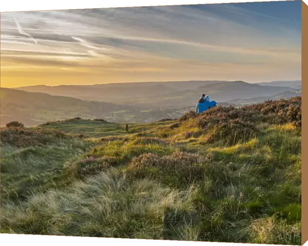 View of couple looking over Hathersage Booths from Millstone Edge
