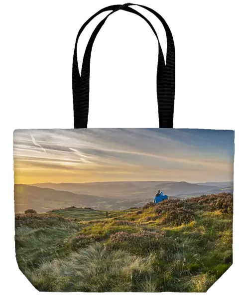 View of couple looking over Hathersage Booths from Millstone Edge