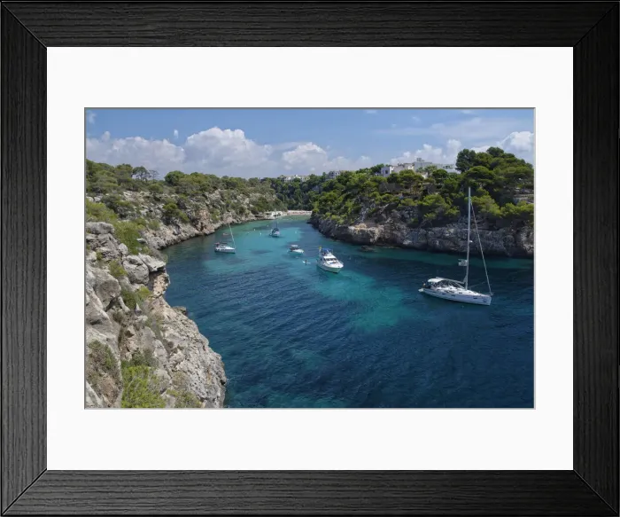 Framed Print : Yachts moored in the cove at Cala Pi, viewed from narrow cliff top coast path Framed Print : Yachts moored in the cove at Cala Pi, viewed from narrow cliff top coast path