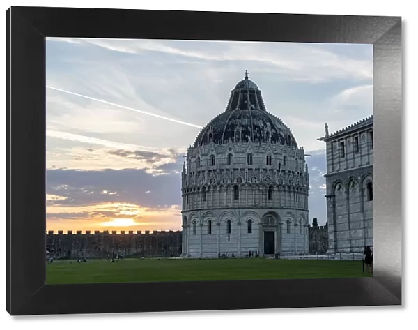 Woman admiring the majestic Pisa Cathedral (Duomo) and Baptistery at sunset