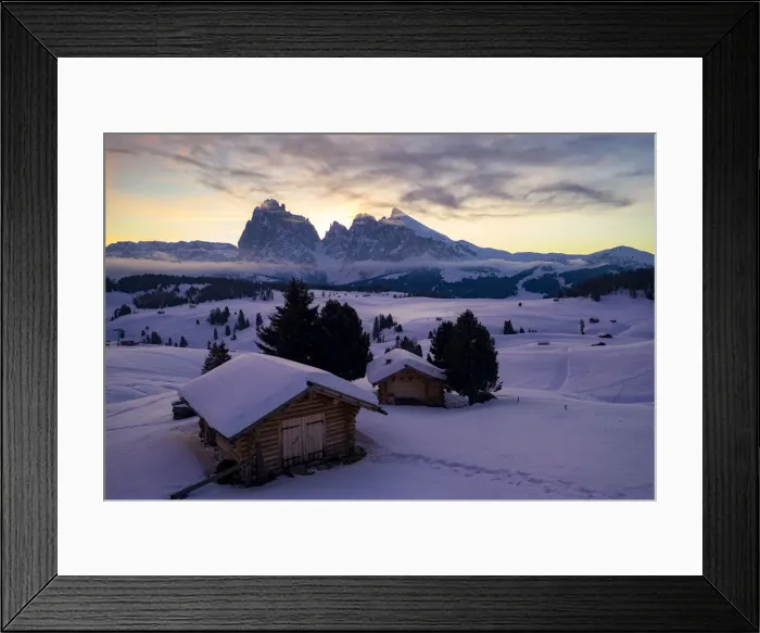 Framed Print : Wood cabins covered with snow with Sassopiatto and Sassolungo in background at dawn Framed Print : Wood cabins covered with snow with Sassopiatto and Sassolungo in background at dawn