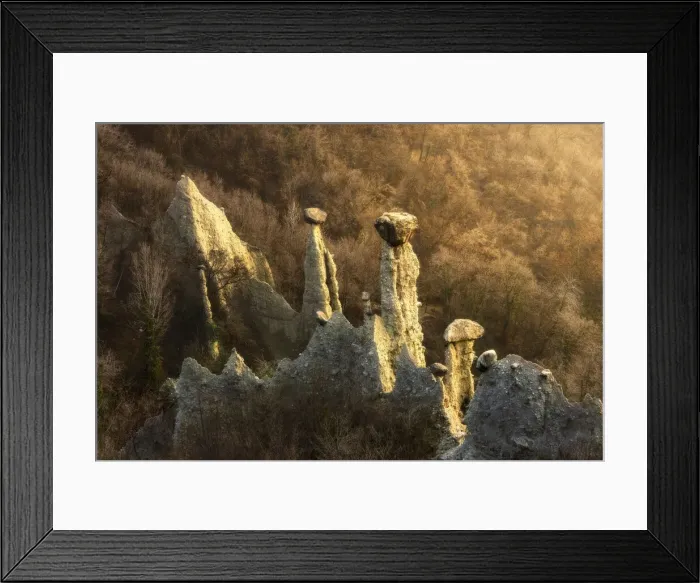 Framed Print : Sunlight illuminates earth pyramids (rock chimneys) of Zone, Zone, Brescia province Framed Print : Sunlight illuminates earth pyramids (rock chimneys) of Zone, Zone, Brescia province
