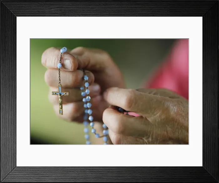 Framed Print : Close-up of a mans hands praying the rosary, France, Europe Framed Print : Close-up of a mans hands praying the rosary, France, Europe