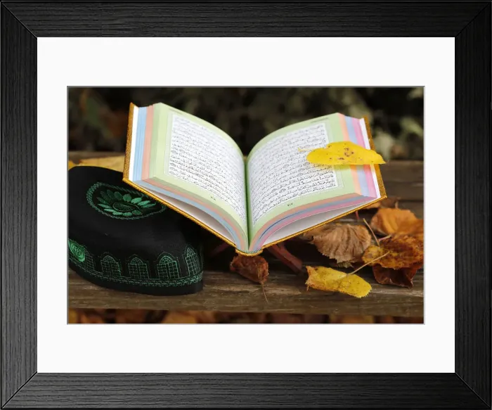 Framed Print : An open Holy Quran on wood stand and a kufi, France, Europe Framed Print : An open Holy Quran on wood stand and a kufi, France, Europe