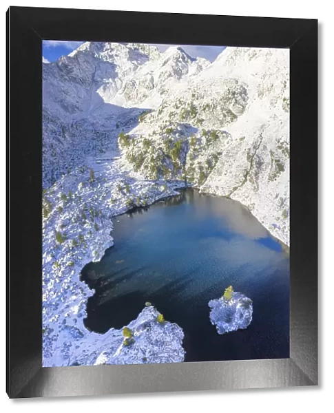 Aerial view of Lago Nero after a summer snowfall, Val Belviso, Valtellina, Orobie Alps