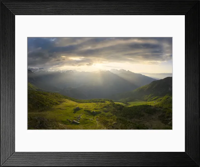 Framed Print : Sun filters between clouds at sunrise with illuminated pasture, Valmalenco, Valtellina Framed Print : Sun filters between clouds at sunrise with illuminated pasture, Valmalenco, Valtellina