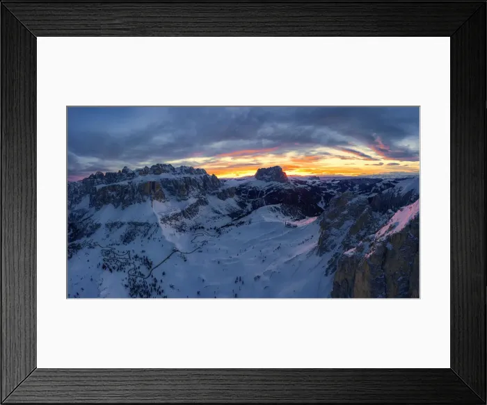 Framed Print : Clouds in the burning sky at sunset over Sassolungo and Sella Group mountains covered Framed Print : Clouds in the burning sky at sunset over Sassolungo and Sella Group mountains covered
