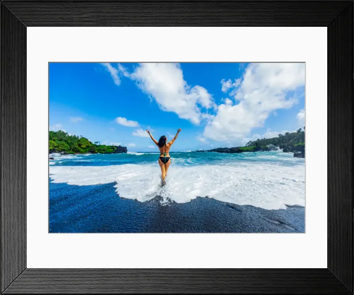 Framed Print : Woman enjoying the sun on one of Mauis black sand beaches, Maui, Hawaii Framed Print : Woman enjoying the sun on one of Mauis black sand beaches, Maui, Hawaii