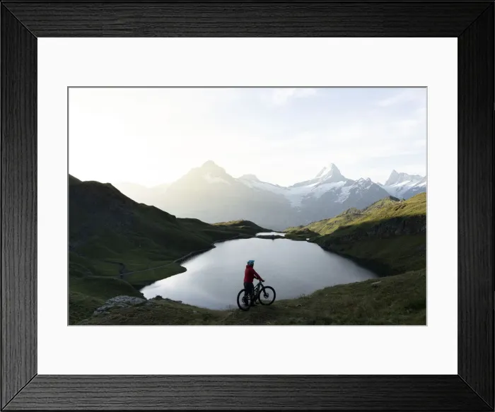 Framed Print : Hiker with mountain bike admiring sunrise over Bachalpsee lake, Grindelwald Framed Print : Hiker with mountain bike admiring sunrise over Bachalpsee lake, Grindelwald