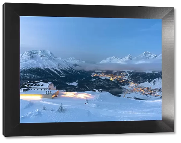 Winter dusk over St. Moritz and Celerina villages covered with snow from Muottas Muragl
