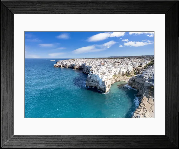 Framed Print : Aerial view of crystal sea surrounding Polignano a Mare on cliffs, province of Bari Framed Print : Aerial view of crystal sea surrounding Polignano a Mare on cliffs, province of Bari