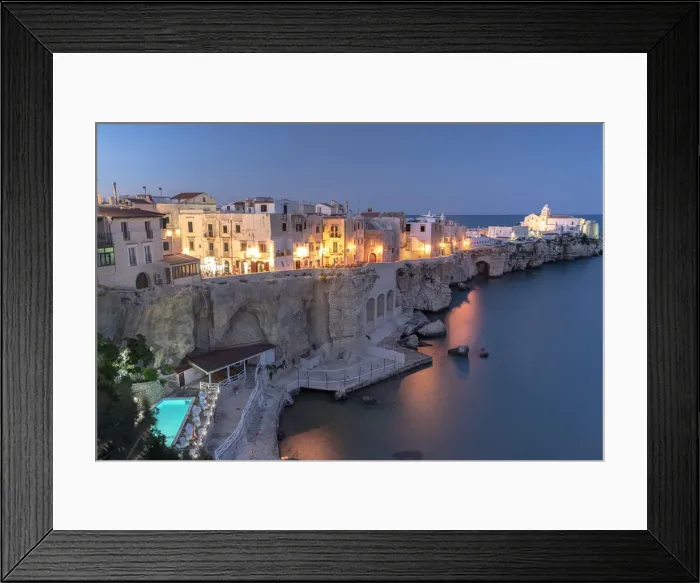 Framed Print : Illuminated pool of luxury resort by the sea at dusk in Vieste old town, Foggia province Framed Print : Illuminated pool of luxury resort by the sea at dusk in Vieste old town, Foggia province