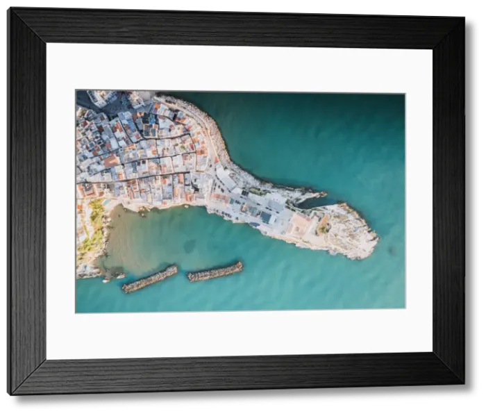 Framed Print : Rooftops of white buildings by the turquoise sea from above, Vieste, Foggia province Framed Print : Rooftops of white buildings by the turquoise sea from above, Vieste, Foggia province