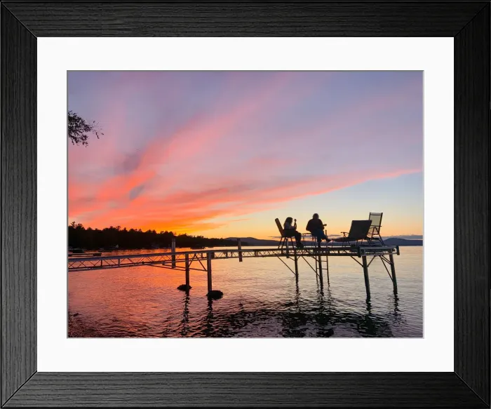 Framed Print : Mother and daughter play ukuleles together on a dock over Sebago Lake, Maine