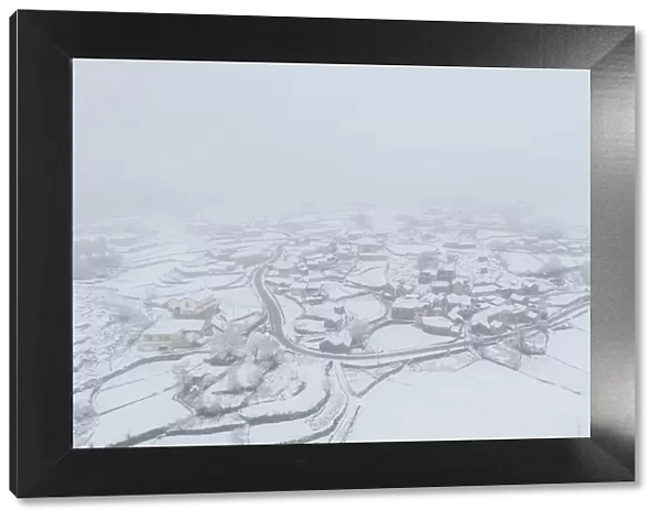 Drone aerial view of a road and remote village covered with snow in Vila Real, Norte