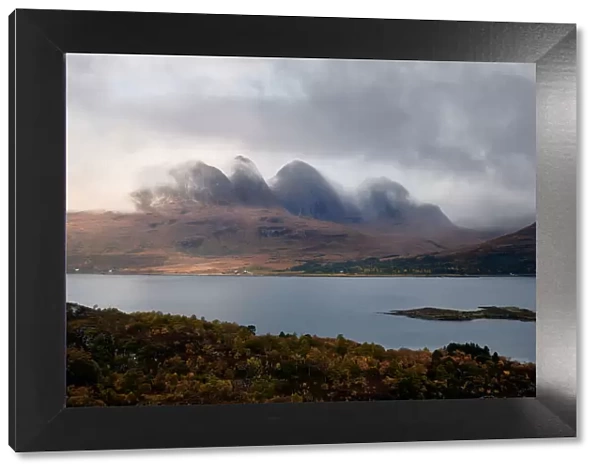 Mountains in the mist facing a lake in the Scottish Highlands, Scotland, United Kingdom