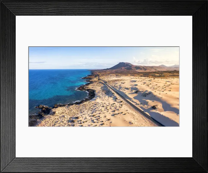 Framed Print : Empty road crossing the sand dunes overlooking the ocean, Corralejo Natural Park Framed Print : Empty road crossing the sand dunes overlooking the ocean, Corralejo Natural Park