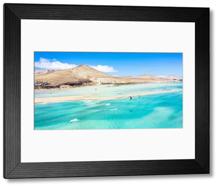 Framed Print : People kiteboarding on waves crashing on white sand of Sotavento beach, Jandia Framed Print : People kiteboarding on waves crashing on white sand of Sotavento beach, Jandia