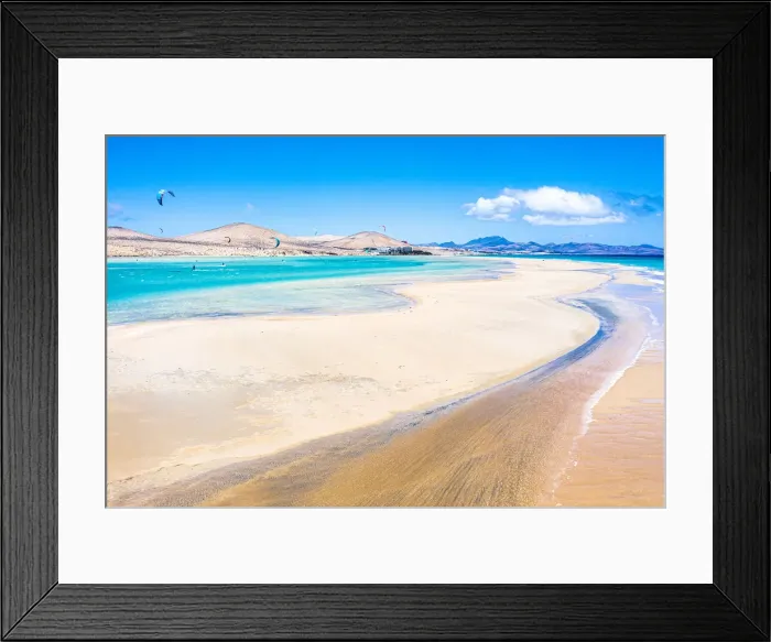 Framed Print : People kiteboarding on waves crashing on white sand of Sotavento beach, Fuerteventura Framed Print : People kiteboarding on waves crashing on white sand of Sotavento beach, Fuerteventura