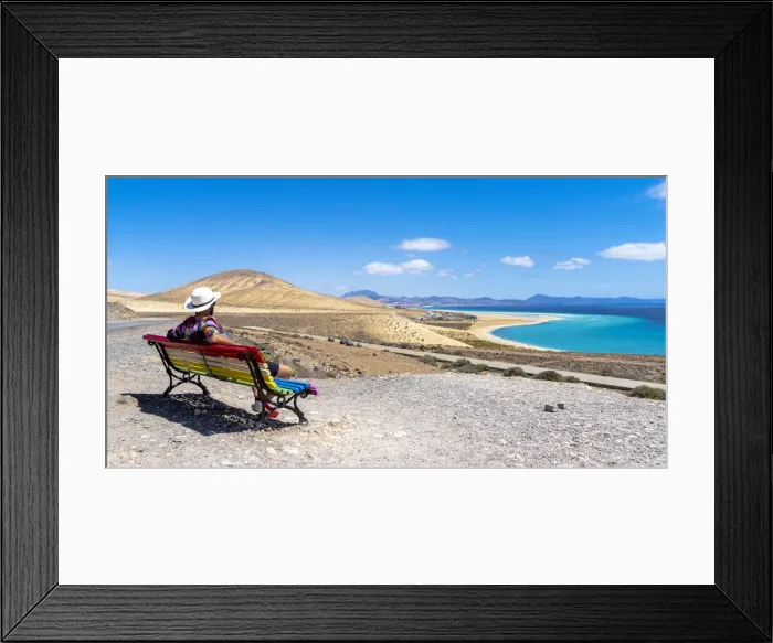 Framed Print : Tourist admiring the crystal ocean from a bench at Mirador Del Salmo viewpoint Framed Print : Tourist admiring the crystal ocean from a bench at Mirador Del Salmo viewpoint