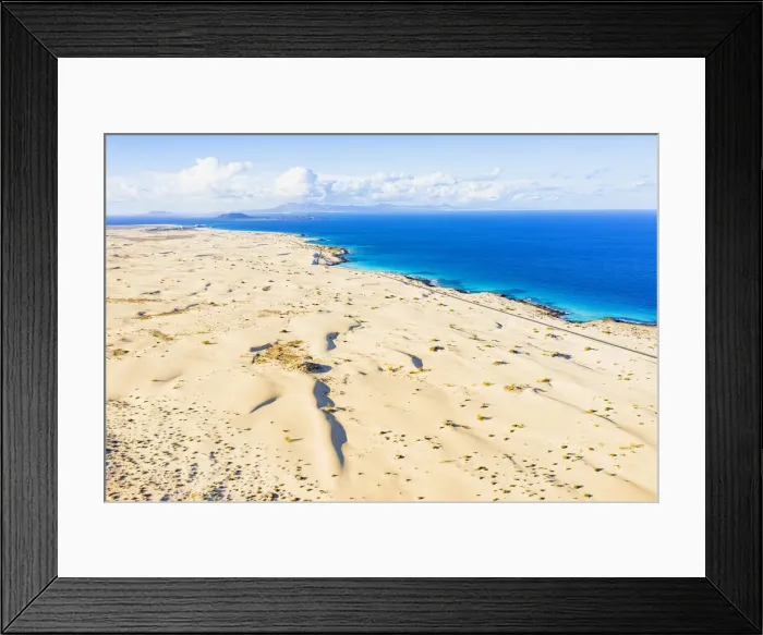 Framed Print : White sand dunes meeting the blue Atlantic Ocean, aerial view, Corralejo Nature Park Framed Print : White sand dunes meeting the blue Atlantic Ocean, aerial view, Corralejo Nature Park