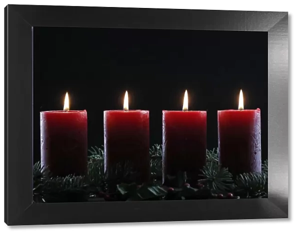 Natural Advent wreath or crown with four burning red candles, Christmas composition