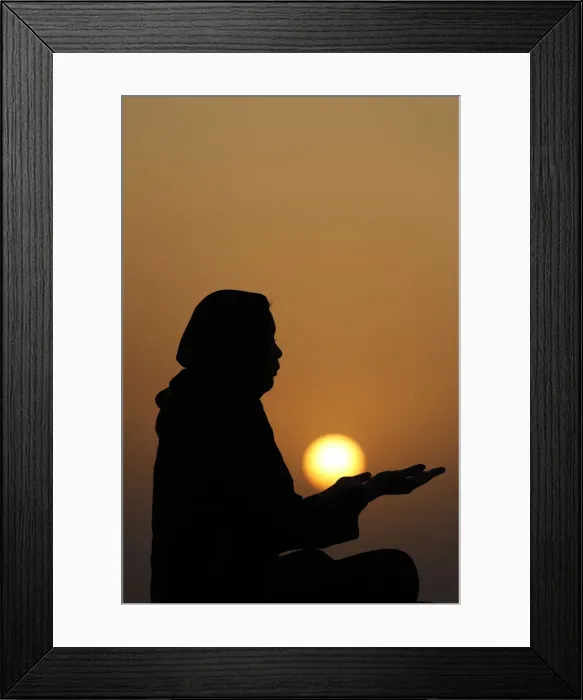 Framed Print : Silhouette of a Muslim woman in abaya praying with her hands at sunset Framed Print : Silhouette of a Muslim woman in abaya praying with her hands at sunset