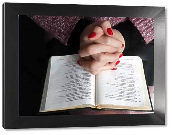 Woman reading the Bible at home, France, Europe