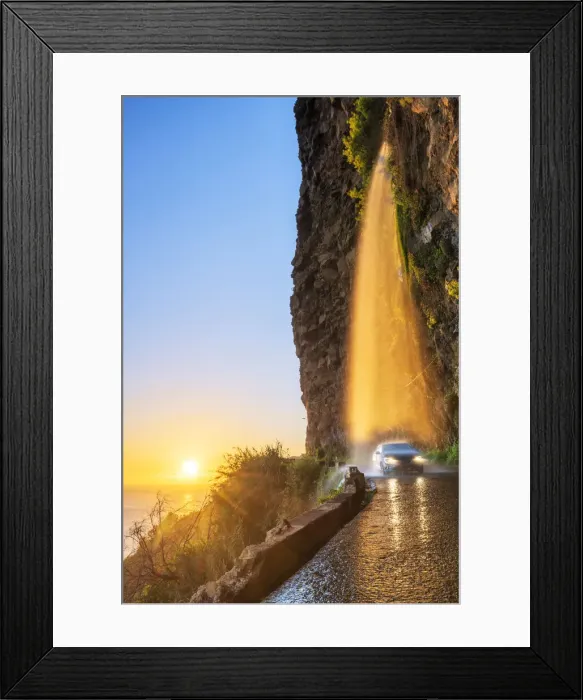 Framed Print : Car passing under Anjos waterfall on slippery coastal road at sunset, Ponta do Sol Framed Print : Car passing under Anjos waterfall on slippery coastal road at sunset, Ponta do Sol