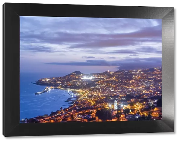 Dusk over the iIluminated city of Funchal viewed from Sao Goncalo, Madeira island