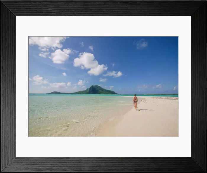 Framed Print : An athletic woman in a bikini walks along the white sandy shoreline of the turquoise Framed Print : An athletic woman in a bikini walks along the white sandy shoreline of the turquoise