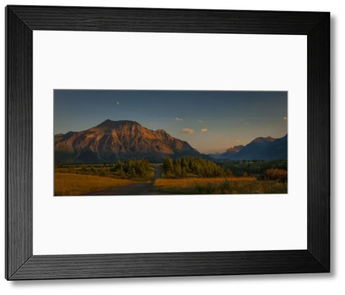 Framed Print : Waterton-Glacier mountains at sunset, UNESCO World Heritage Biosphere site with a lone Framed Print : Waterton-Glacier mountains at sunset, UNESCO World Heritage Biosphere site with a lone